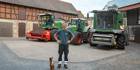 Björn Kaiser in the farmyard with some of the Fendt Full-Line range.