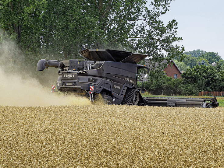 Rear view of the Fendt IDEAL 9T threshing in a wheat field.