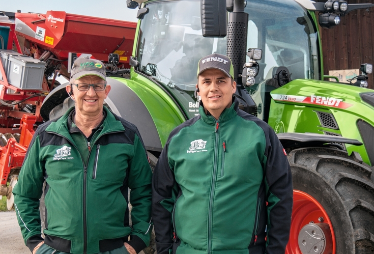 Rudolf and Daniel Bolliger stand in front of a Fendt 724 Vario.