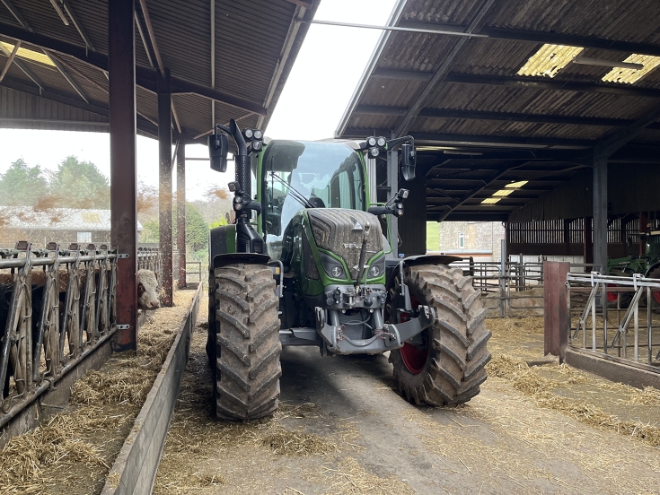 John Whiteford drives his Fendt 516 Vario through the cow shed.