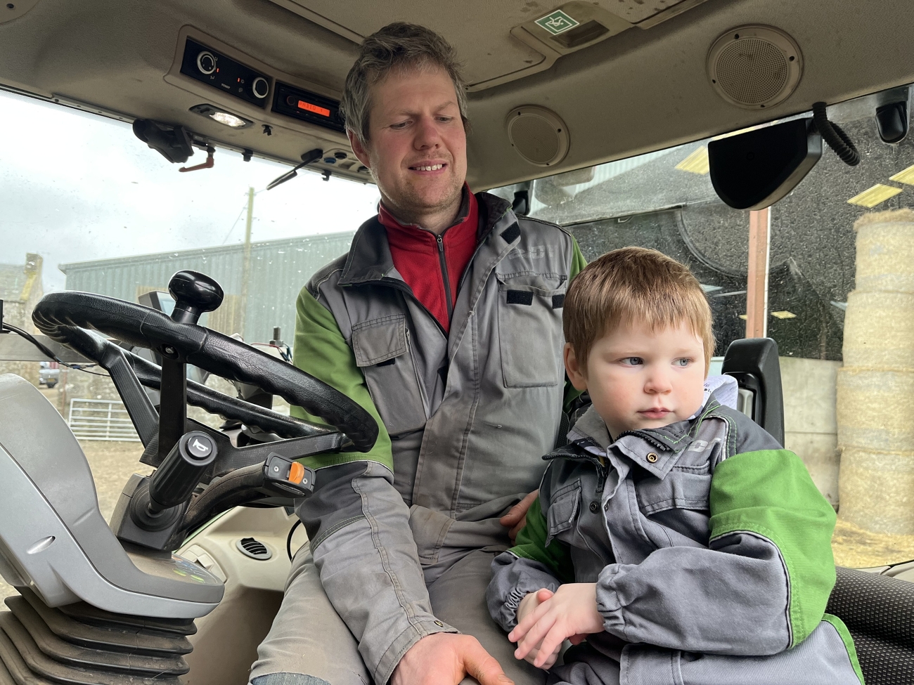 Johne Whiteford and his son sit on a tractor.